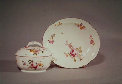 Mennecy Sugar bowl with its quatrefoil shaped charger, decorated with a multicoloured flower design by French School